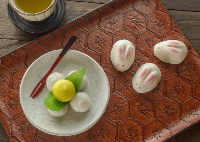 The cultural offerings of Tsukimi, featuring tsukimi mochi and rabbit-shaped mochi.